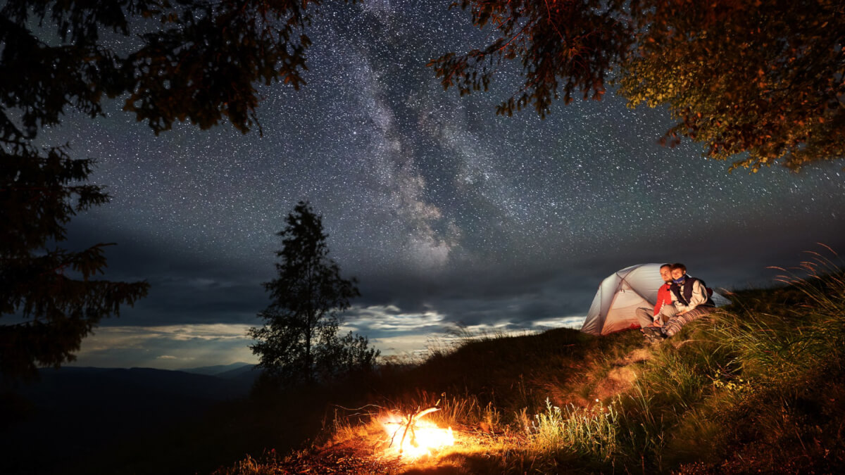 couple-with-tent-sitting-bonfire-1